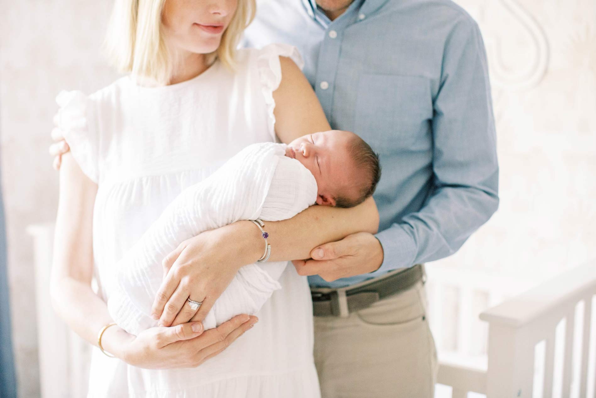 Mom and dad holding a baby - Lighthouse Chiropractic and Wellness