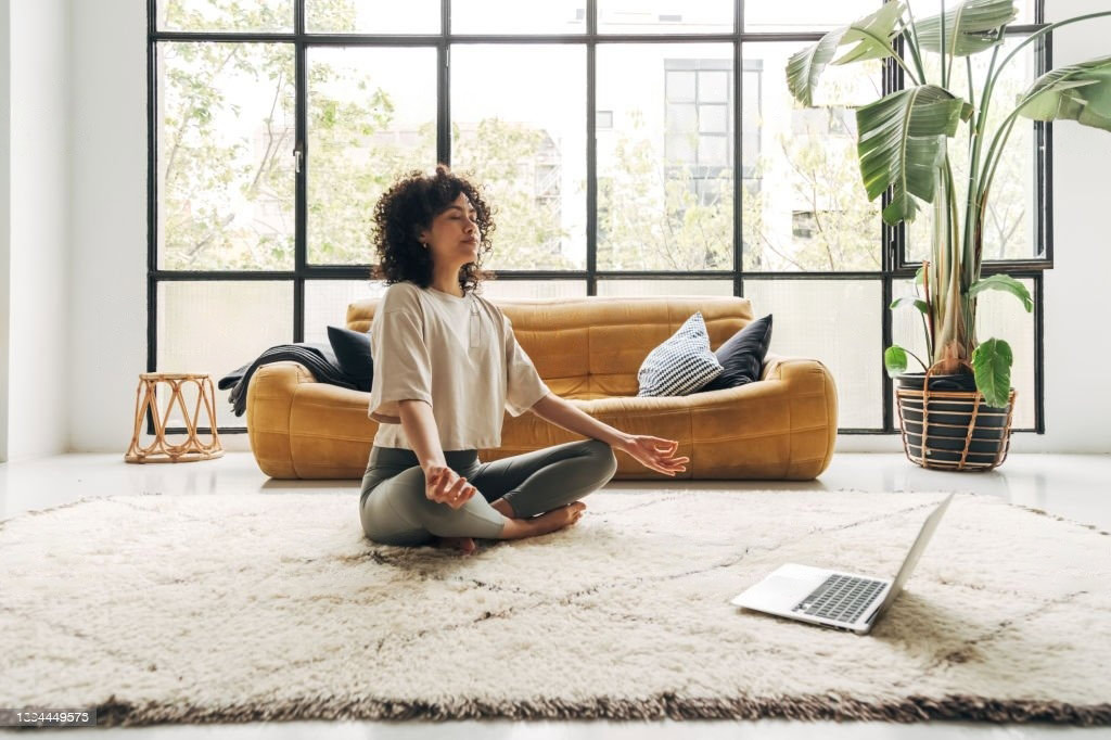 Lady meditating on the carpet - Lighthouse Chiropractic and Wellness